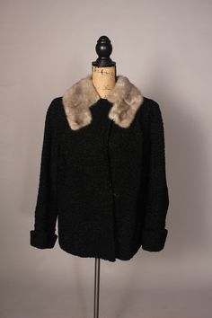 Wonderful vintage 40's black curly lamb wool coat with silver fur collar, and beautifully lined!  From P. Crandell Furs in Omaha, and has both ABM and ABW monogrammed inside.  Large hook and eye closure at the front, and a button at the neck...it looks like it can be worn several ways--see pics.  A little wear at some of the edges--also see pics. Bust:42" Waist:44" Length:27" Sleeve:19" ish Shoulder to shoulder:15" Label:  P Crandell Furs Omaha  ABM ABW 2894 Elegant Winter Outerwear For Vintage Fashion, Elegant Vintage Winter Outerwear, Vintage Fur Coat For Winter Formal Occasions, Vintage Fur Coat For Winter Formal, Vintage Fur Coat For Formal Winter Occasions, Vintage Winter Fur Coat For Formal Occasions, Vintage Winter Evening Outerwear, Formal Vintage Outerwear With Faux Fur Trim, Vintage Formal Fur Coat With Faux Fur Trim