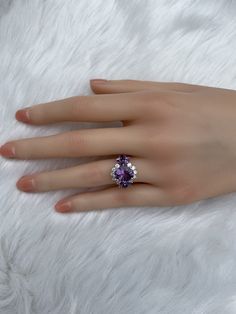 The key stone of this ring is a 11x9mm natural amethysts, and the main material of this ring is sterling silver plated with 18k white gold. On each side of the main stone are one 5x3mm and two 5x2.5mm amethysts. The small accent stones and zircon emphasize the big size of the key stone. Amethyst is a birthstone for February, and the color purple is meant to bring wealth and royalty. Also, many people believe amethyst has the power to relieve stress and purify the mind. Size: Adjustable and fitab