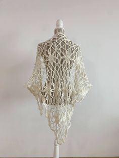 "This is a beautiful vintage soft mohair crochet lace shawl in off white color. This fluffy lace shawl is made of soft warm yarn which will keep you cozy during the winter days and yet it will make you feel gorgeously stylish. This bohemian shawl has a fishnet floral pattern. Perfect mohair wrap for the fall/ winter season. This boho shawl will add a pop of romantic cottagecore style to your outfit.   This women triangle shawl is the perfect gift for your sister, mother or grandmother. Era: Y2K Condition: This mohair shawl is in great vintage condition with some signs of wear. Perhaps the fabric was fluffier before, but it still looks awesome.  Measurements:  Length: 65\" / 165 cm  Width: 41.3\"  /105 cm  Colors: off white Material: not marked feels like mohair wool Shipping: I will ship y Handmade White Shawl For Spring, Bohemian Lace Shawl With Lace Work, White Handmade Shawl For Spring, Traditional White Summer Shawl, Traditional White Shawl For Summer, Bohemian Cream Crochet Lace Shawl, White Bohemian Shawl For The Beach, White Bohemian Shawl For Beach, Fitted Bohemian Shawl For Wedding