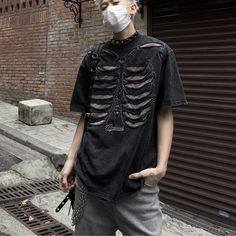 Add some edgy style to your wardrobe with our Retro Skeleton Hole Embroidery Oversize T-shirt. This unique t-shirt features a bold skeleton design with intricate embroidery detailing, giving it a standout look that's sure to turn heads. The oversize fit provides a comfortable and relaxed feel, perfect for casual wear or dressing up for a night out. Features: -100% Cotton -Crew neck -Bold Skeleton graphic -Oversize fit -Unisex style Distressed Skull Top In Punk Style, Distressed Skull T-shirt In Edgy Style, Gothic Distressed Tops For Streetwear, Emo Skull Print Short Sleeve Tops, Emo Short Sleeve Top With Skull Print, Oversized Emo Streetwear Tops, Oversized Crew Neck T-shirt For Alternative Fashion, Oversized Edgy T-shirt With Skull Print, Skull Print T-shirt For Alternative Fashion