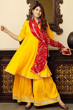 YellowSolid Flared Kurta Set Paired with Plazzo and Tafta Dupatta/ Bandej Print Product Features: Color: Mustard Fabric: Cotton Work: Gota Work Neckline: Round Neck Dupatta: With Dupatta Package Content: Kurta, Bottom and Dupatta Occasion: Festival Disclaimer: There will be slight difference in digital to actual image Plazzo Set, Flared Anarkali, Layered Kurta, Kurta And Palazzo, Kurta Palazzo Set, Flared Palazzo, Angrakha Style, Red Flare, Palazzo Set