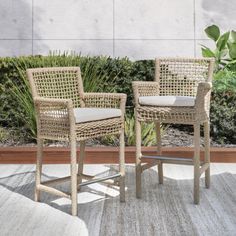 two wicker chairs sitting next to each other