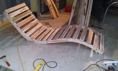 a wooden bench made out of pallets in a garage