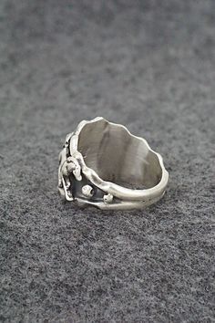 This sterling silver ring featuring horses was made by Navajo silversmith Genevieve Francisco. The inside is partially stamped RB and .925Size: 9.75Width: 3/4"Free shipping on all orders! We ship with USPS and always include tracking. All orders ship within a day of payment.Returns are accepted up to 30 days after you receive your order. Just send us a message. Our shop offers cash back or store credit. The item must be returned in new condition. Collectible Sterling Silver Ring With Wide Band, Sterling Silver Stamped Rings For Collectors, Unique Stamped Antique Silver Rings, Unique Stamped Silver Rings, Nickel-free Southwestern Sterling Silver Rings, Sterling Silver Skull Ring Stamped 925 For Promise, Southwestern Style Nickel-free Sterling Silver Rings, Nickel-free Silver Rings In Southwestern Style, Nickel-free Silver Southwestern Rings