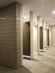 a row of urinals sitting next to each other in a room with tiled floors