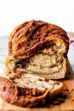 a loaf of cinnamon swirl bread sitting on top of a cutting board