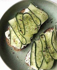 an open face sandwich with cucumber slices on it