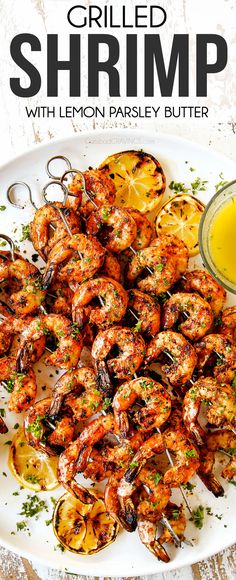 grilled shrimp with lemon parsley butter on a white plate next to a glass of orange juice