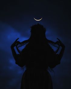 a woman standing in the dark with her hands on her hair and half moon above her head