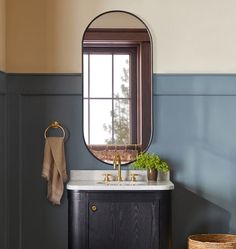 a bathroom sink with a mirror above it and a towel rack on the wall next to it