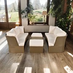 a living room with wooden floors and white furniture