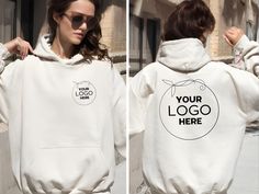 a woman wearing a white hoodie that says your logo here