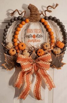 a pumpkin wreath hanging on the front door