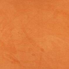 an orange colored surface with some stains on it