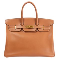 100% authentic Hermès Birkin 35 bag in Gold (camel brown) Veau Epsom leather. Lined in Chevre (goat skin) with an open pocket against the front and a zipper pocket against the back. Has been carried with soft wear to the corners, a tiny dark spot on the back, some pen marks on the lining, a soft lighter spot on the inside bottom and a small scratch on the outside gusset. Overall in very good condition. Comes with lock, keys and clochette. Measurements Height 25cm (9.8in) Width 35cm (13.7in) Depth 17cm (6.6in) Drop of the Handle 10cm (3.9in) Hardware Gold-Tone Blindstamp D in a square (2000) All our listings include only the listed item unless otherwise specified in the description above. Hermes Birkin 35, Hardware Gold, Hermes Bags, Hermes Birkin, Canvas Bag, Fashion Handbags, Zipper Pocket, Bags Handbags, Leather Straps