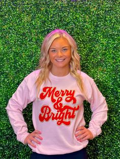 This Merry & Bright Chenille Sweatshirt is the perfect way to start your morning in style. With its light pink coloring, cozy chenille fabric, and Christmas-inspired graphics, it's sure to keep you warm and festive all season long! Adult sizes only. Get yours today. Unisex sizing and fit Pictured: Light Pink Sweatshirt SPECIAL CARE - WASHING INSTRUCTIONS: Hand washing and air drying are always best for these items. Wash on delicate, cold, and inside out. Always air dry to prevent lint from sticking to the letters and for longevity of your beautiful items! Festive Pink Crew Neck Top, Christmas Pink Cotton Tops, Pink Cotton Christmas Tops, Pink Cotton Holiday Sweatshirt, Cozy Pink Graphic Print Top, Cozy Pink Top With Graphic Print, Holiday Pink Long Sleeve Tops, Pink Long Sleeve Holiday Top, Pink Festive Winter Top