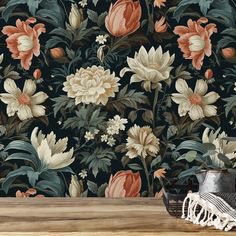 a wallpapered with flowers and leaves on a wooden table next to a pair of shoes