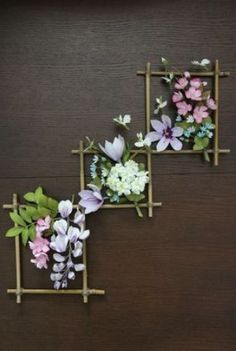 three wooden frames with flowers on them