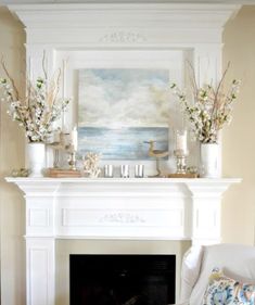 a living room filled with furniture and a fire place under a painting on the wall