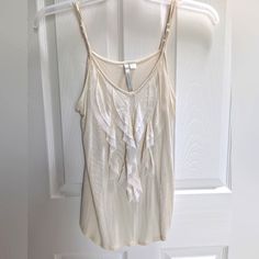 This Cream Color Lc Top Is 100% Rayon (Very Soft) With Doubled Spaghetti Straps. Feminine & Stylish Ruffle Front Tank Top. Great For Layering! Size M (Runs Small) 16" Pit-To-Pit / 19" Length. Euc (Never Worn). Pet/Smoke Free Environment. Spring Cream Tank Top With Built-in Bra, Beige Spring Tank Top With Built-in Bra, Beige Tank Top With Built-in Bra For Spring, Beige Ruffled Tank Top For Summer, Stretch Ruffles Camisole, White Ruffled Tank Camisole, Sleeveless Stretch Ruffled Camisole, White Stretch Tank Top With Ruffles, Cream Camisole Top With Built-in Bra