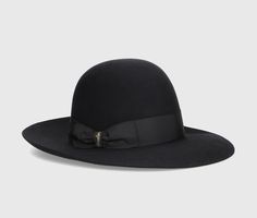 The Eleonora hat is a timeless symbol of Borsalino excellence. The model is made from superior quality smooth folar felt, known for its smooth finish and soft touch, ensuring superior comfort and durability over time. This hat is unlined and offers a light and comfortable fit. The design features an open crown and a 4 cm wide grosgrain ribbon. The brim is wide and measures approximately 8 cm. Each Borsalino felt hat takes seven weeks to be handcrafted by our skilled artisans at the Maison in Alessandria, whose passion and craftsmanship are expressed in every single piece. The Borsalino handmade production process involves more than 50 steps and is passed down from generation to generation. Composition: 100% Felt Elegant Flat Crown Hat, Luxury Adjustable Felt Hat, Luxury Fur Felt Hat With Flat Crown, Luxury Felt Hat For Kentucky Derby, Luxury Fur Felt Fedora With Flat Brim, Luxury Adjustable Fedora Felt Hat, Luxury Adjustable Felt Fedora Hat, Elegant Wool Brimmed Hat, Elegant Adjustable Wool Felt Hat