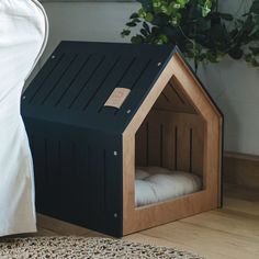 there is a dog house made out of wood and has a bed in the corner