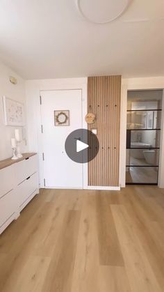 an empty living room with wood floors and white walls