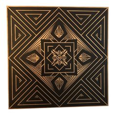 a black and gold wall hanging with an intricate design