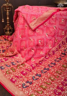 This magnificent Authentic Hand Bandhej on Meenakari Shikargah Banarasi Silk Georgette Saree in Peach is a striking fusion of artforms. Indian craftsmanship combine to form a beautiful and lively piece, guaranteed to spark joy. Its vivid border and body are adorned with Georgetti Meenakari Shikargah motifs, complemented by the delicate Bandhni work of Gujarat. The wide skirt border and intricate Sarkam bandhej work add to the exquisiteness of the product! SILK MARK CERTIFIEDThis saree is ready t Bollywood Lehenga With Motifs, Jamawar Anarkali Set For Navratri, Brocade Sharara With Pallu, Designer Wear Sharara With Meenakari, Pink Bollywood Pre-draped Saree With Meenakari, Unstitched Meenakari Sharara, Designer Red Paithani Silk Pre-draped Saree, Semi-stitched Sharara With Motifs, Traditional Pre-draped Paithani Silk Saree