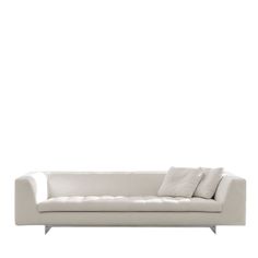 a white couch sitting on top of a wooden floor