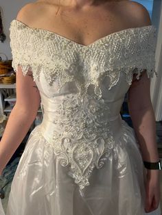 a woman in a white wedding dress looking at the camera