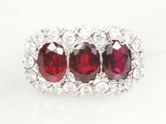 This Vintage 14k Natural Ruby and Diamond Ring is magnificent! The oval rubies are genuine and high quality with a deep red color and good transparency. A GIA certification was obtained for the center ruby and identifies that these are natural ruby stones. The rubies measure approximately 6.64 x 4.84 x 3.79 mm each which equates to approximately 1.0 carats each by calculation or a total of 3.0 carats of rubies in total. They are surrounded by sparkling diamonds. In all there are twenty full cut Oval Red Ruby Ring With Three Stones, Luxury Oval Three-stone Ruby Ring, Three Stone Oval Ruby Ring, Ruby Diamond Ring, Ring Three Stone, Statement Rings Diamond, Diamond Bows, Ruby Diamond Rings, Blue Stone Ring