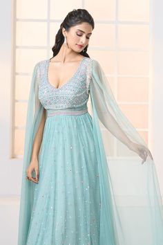 Teal blue soft net gown with all-over hand embroidery, cascading draped sleeves and tassel details on shoulders. - Aza Fashions Light Blue Anarkali Dress With Intricate Embroidery, Evening Gown With Dupatta And Cape Sleeves, Evening Gown With Cape Sleeves And Dupatta, Floor-length Wedding Gown With Embroidered Sleeves, Organza Dress With Dupatta And Cape Sleeves, Light Blue Floor-length Dress With Intricate Embroidery, Reception Gown With Sheer Dupatta And Cape Sleeves, Elegant Light Blue Dress With Dupatta, Blue Evening Gown With Resham Embroidery