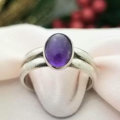 RETRO-STYLE Sterling Silver Oval Cabochon Amethyst Double Banded Ring- Beautifully Crafted.  Made in the 1980s.  Amethyst is the Birthstone for the Month of February. This Ring Would Make a Wonderful Birthday Gift! This Darling Ring is Petite is Size but Mighty in Color! Made from Solid and Stamped Sterling Silver, this Ring features an Oval Cut Cabochon Amethyst Gemstone that is a Rich, Deep Purple Color.  The Cabochon Amethyst measures 9mm in Length x 6mm Wide The Band measures 5mm in Width Si Luxury Amethyst Oval Cabochon Ring For Formal Occasions, Vintage Silver Ring, Month Of February, Double Band Rings, Vintage Silver Rings, Purple Gems, Deep Purple Color, Yellow Gold Wedding Band, Pretty Pendant