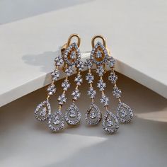 Add a touch of glamour to your look with our Glitz CZ Sparkle Earrings, crafted passionately in silver and adorned with unique 5A lab-created diamonds by CZ. These luxurious stones create a vivid and high-quality appearance, giving the earrings a real diamond feel. Finished with 18kt gold accents and a highly-reflective rhodium polish, these earrings are not only dazzling but also durable, ensuring they maintain their sparkle for years to come. Finish: Yellow Gold Plating Material: Silver, Alloy Glamorous Bridal Earrings, Diamond With Brilliant Cut, Glamorous Diamond Bridal Earrings With Brilliant Cut, Hand-set Diamond Earrings, Fine Jewelry, Diamond Clip-on Earrings For Formal Events, Diamond Clip-on Earrings For Formal Occasions, Hand Set Diamond Earrings Fine Jewelry, Formal Diamond Clip-on Earrings, Dazzling Brilliant Cut Chandelier Earrings For Formal Occasions, Dazzling Brilliant Cut Chandelier Earrings For Formal Events