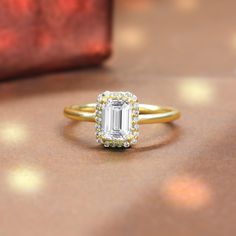 a close up of a ring with a diamond on the side and a baguette in the background