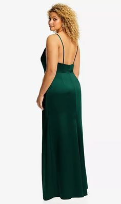 a woman in a green dress looking back