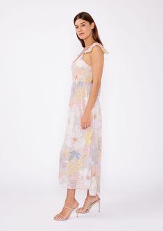 A romantic bohemian summer maxi dress designed in a feminine pink floral print. Floral print Chiffon Slim fit top Relaxed, flowy skirt Short flutter cap sleeve Maxi length Scoop neckline Adjustable spaghetti straps Half-elastic waist at the back Open back with tie detail Lined Bohemian maxi dress A feminine floral print maxi dress that captures the essence of carefree summer days. Featuring short flutter cap sleeves and a scoop neckline, complimented by adjustable spaghetti straps for a comforta Spring Beach Floral Dress With Smocked Bodice, Feminine Summer Chiffon Maxi Dress, Feminine Chiffon Maxi Dress For Summer, Flowy Chiffon Sundress For Spring, Pink Midi Dress With Ruffled Straps For Garden Party, Summer Chiffon Midi Dress With Ruffled Straps, Summer Floral Dress With Smocked Bodice For Beach, Spring Chiffon Midi Dress With Ruffled Straps, Spring Maxi Dress With Smocked Back And Flowy Skirt