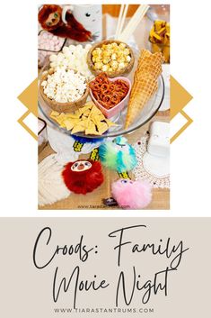 a table topped with lots of food and popcorn on top of it, next to the words cords family movie night