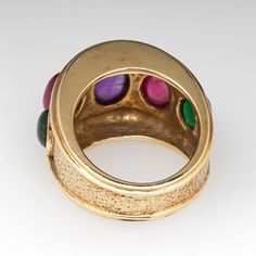 This beautiful ring is centered with one (1), bezel set, oval cabochon cut natural amethyst and is flanked to each side by one (1), bezel set, oval cabochon cut natural pink tourmaline and one (1), bezel set, oval cabochon cut natural green tourmaline. The ring measures 16.1mm at the top, rises 9.0mm above the finger, tapering to 7.1mm wide and 1.5mm thick at the base of the shank. It is currently a size 6.5. Luxury Multi-stone Oval Cabochons, Yellow Gold Multi-stone Cabochons For Fine Jewelry, Yellow Gold Multi-stone Cabochons Fine Jewelry, Formal Multi-stone Oval Cabochon Gemstones, Formal Rings With Bezel Setting And Oval Cabochon, Yellow Gold Multi-stone Oval Cabochon Gemstones, Yellow Gold Oval Cabochon Gemstones, Heirloom Multi-stone Oval Cabochon Rings, Oval Multi-stone Ruby Ring