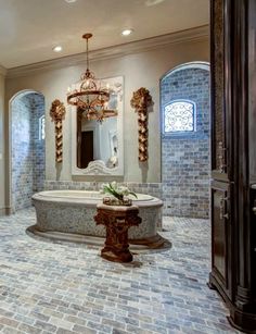 a bathroom with a tub and chandelier in the center, surrounded by arched doorways