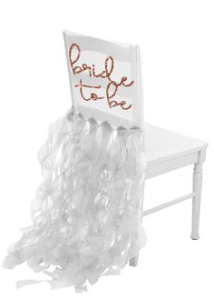 a bride to be chair with ruffles on the bottom and gold foil lettering