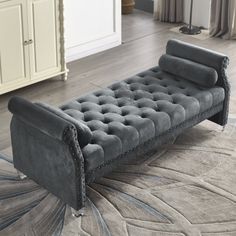 a large gray couch sitting on top of a rug