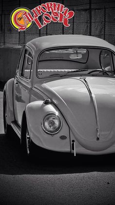 an old vw bug parked in front of a building