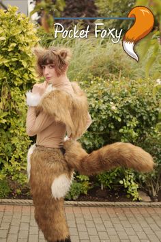 a woman dressed as a fox is posing for the camera