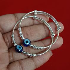 Newborn Baby Bangle, Adjustable Silver Baby Protection Bangle, Baby Nazariya, Evil Eye Baby Jewelry, Unisex Kids Bangle, New Baby Gift ➤ PRODUCT DETAILS ✦ Item Code:--------- GJP-1428 ✦ Item Weight:------- 9.80 grams (Approx.) ✦ Metal:---------------- Pure Silver ✦Diameter:------------ 1.70 Inch (Approx.) Note:- All the items appear larger than actual in size so please check measurements carefully before purchase. THIS PRODUCT CAN BE GIFTED ON THE FOLLOWING OCCASIONS:- Birthday Gift, Anniversary Gift, Wedding Gift, Baby Shower Gift, Graduation Ceremony, Friendship Day Gift, Daughter's Day Gift, Independence Day, Mother's Day Gift, Housewarming Gift, Women's Day Gift, Father's Day Gift, Easter Gift, Valentine's Day Gift, Black Friday, Thanksgiving Day, Christmas Gift, Personalized Gift M O Silver Baby Bracelet, Kids Bangles, Friendship Day Gifts, Baby Bangles, Modern Gold Jewelry, Baby Bracelet, Baby Jewelry, Baby Protection, New Baby Gift