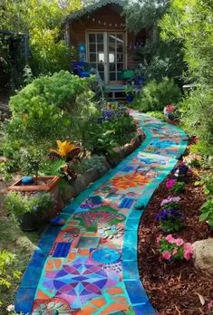 a garden path made out of colorful tiles