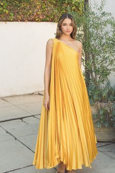 One shoulder pleated maxi dress featuring a self tie detail at the shoulder. NOTE: If your size is not available, please register your email in EMAIL ME WHEN AVAILABLE link.