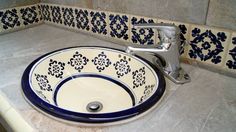 a blue and white sink sitting on top of a counter