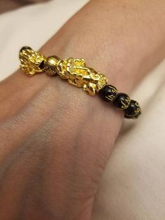 Check out this item in my Etsy shop https://www.etsy.com/listing/874554417/mens-or-ladies-lucky-feng-shui-bracelet Spiritual Gold Jewelry With Dragon Design, Gold Stretch Bracelet With 108 Round Beads, Gold Wristband With 8mm Beads, Symbolic Gold Beaded Bracelets As Gift, Symbolic Gold Beaded Bracelets For Gifts, Symbolic Hand-strung Gold Bracelets, Symbolic Gold Bracelets For Festivals, Gold Jewelry With 8mm Beads For Blessing, Gold Spiritual Wristband With Round Beads